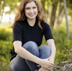 Deputy Director of Student Services sitting outside in nature 