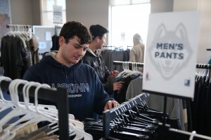 Photo of a man looking through clothes