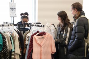 Photo of students looking through clothes
