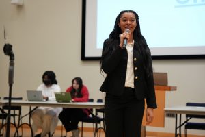 A photo of Chief Diversity Officer, Phoenix Harper, at a USG Senate meeting