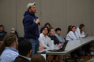 A photo of someone speaking at a USG Senate meeting