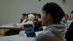 A photo of an audience member at a USG Senate meeting