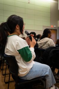 Audience member asking a question at a Diversity and Outreach event